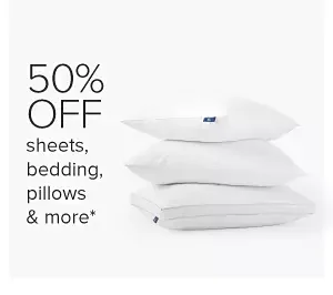 Folded quilts and a pillow. 50% off sheets, bedding, pillows and more.