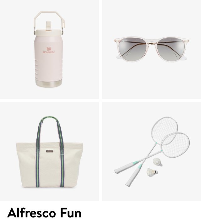 A Stanley water tumbler, sunglasses, a tote bag and pickleball set. 