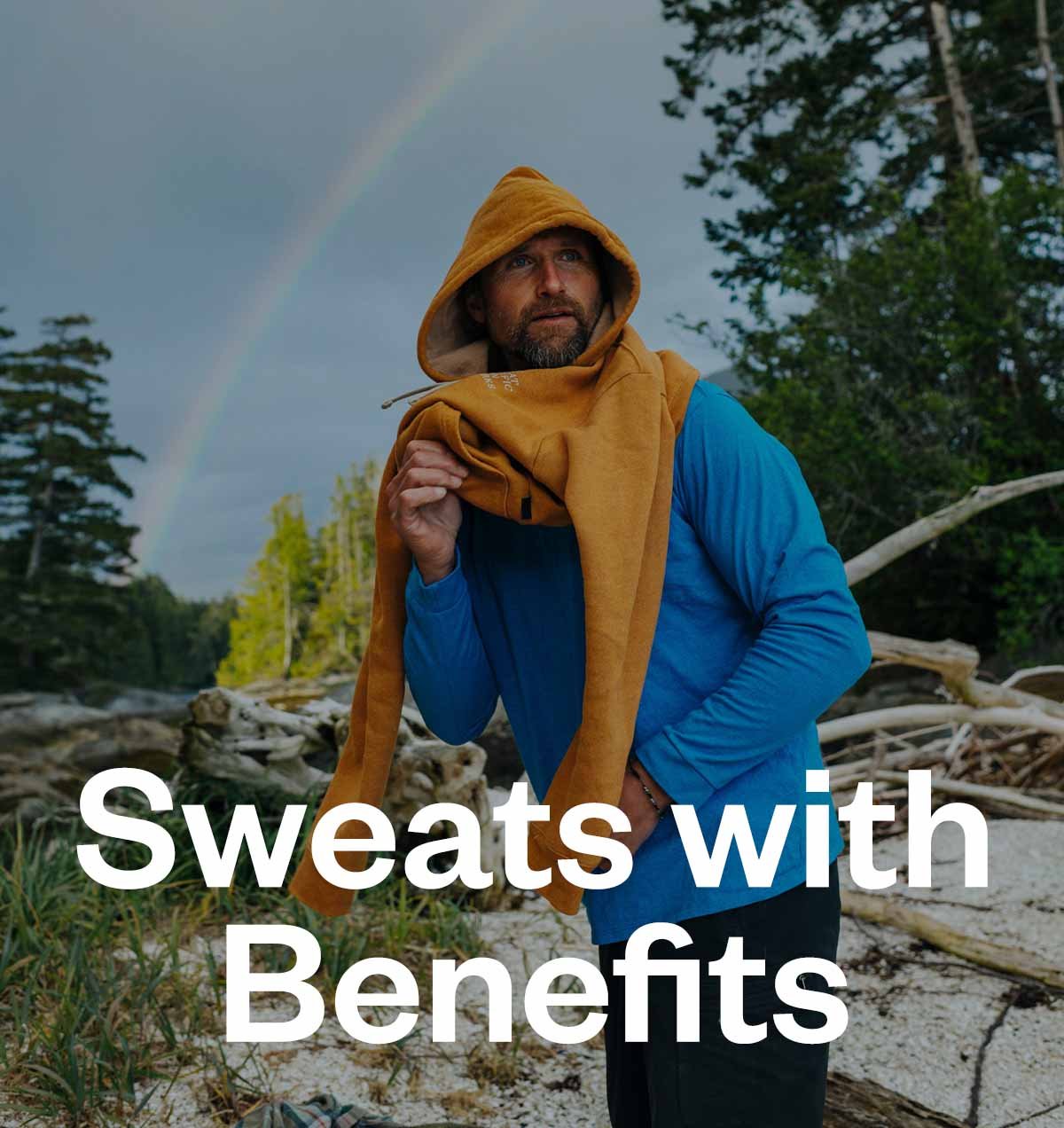 Sweats with benefits. A person puts on an orange sweatshirt with a rainbow in the sky behind them. 