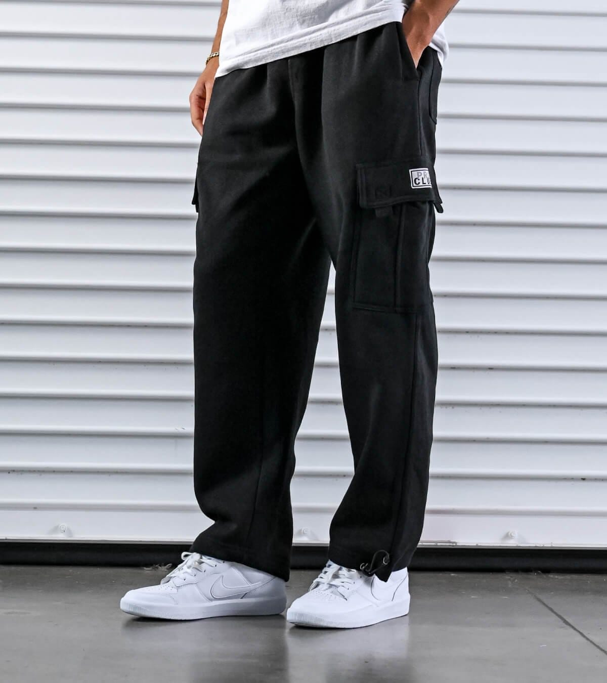 Man wearing black Pro Club branded cargo sweatpants
