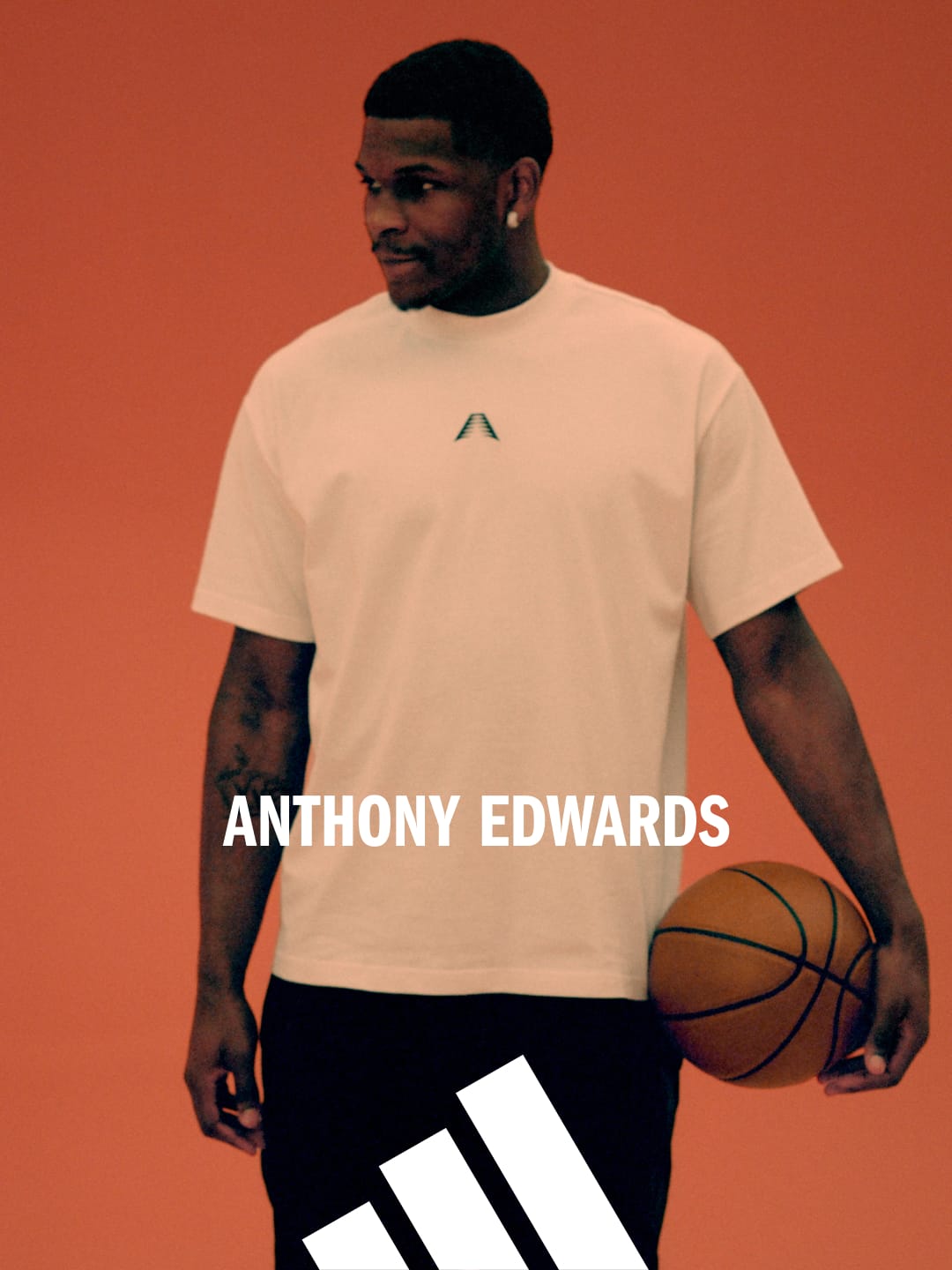 Anthony Edwards standing in front of a red-orange background holding a basketball.