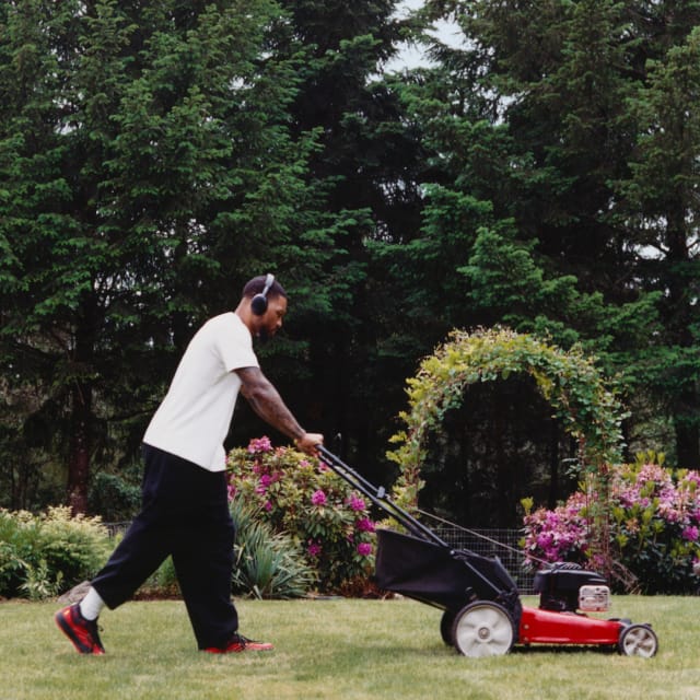 Damian Lillard mowing grass in the adidas Dame 9 Bape® sneaker