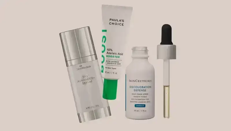 Best Dark Spot Correctors 2024: Three bottles of skin-care products from SkinMedica, Paula's Choice, and SkinCeuticals on a beige background