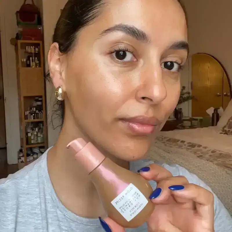 A woman holding a bottle of a bronzed serum, next to a close up photo of the bottle on a tan background