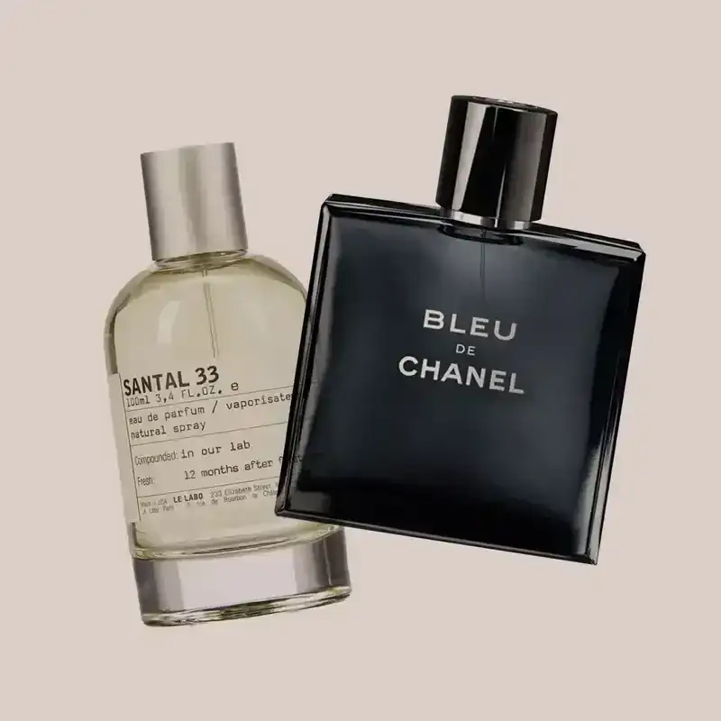 Bottles of fragrances from Chanel and Le Labo on a beige background