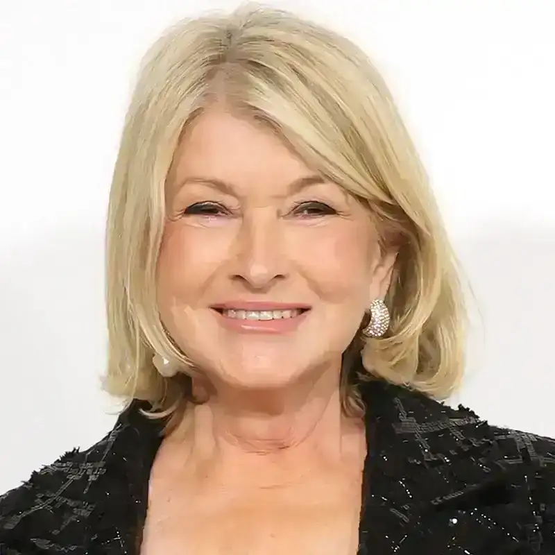 Martha Stewart poses at an event in a black sequined jacket and top.