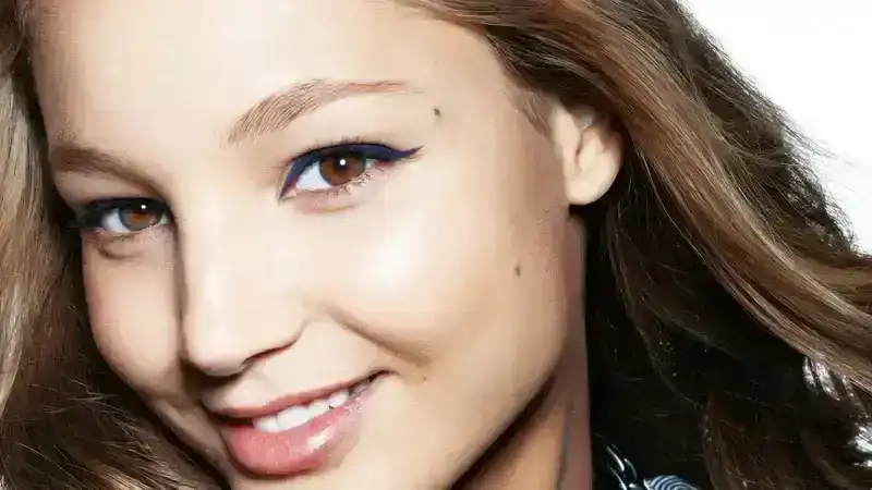 Portrait of tween in striped shirt with blue eyeliner