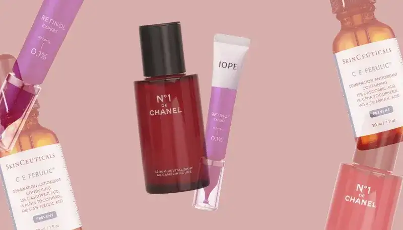 Cosmetic items overlapping on a pink background. Center: Red bottle and thin squeezable tube. Sides: Amber bottle and thin tubes.