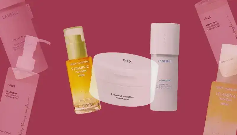 Cosmetic items overlapping on a dusty pink background. From left to right: Yellow-tinted clear bottle with spray cap, white disc-shaped jar, and white tube with hard cap 