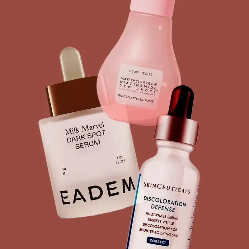 3 cosmetic items overlapping on a brown background. From top to bottom: pink bulbous bottle, white bottle with dropper top and white bottle with black dropper top.