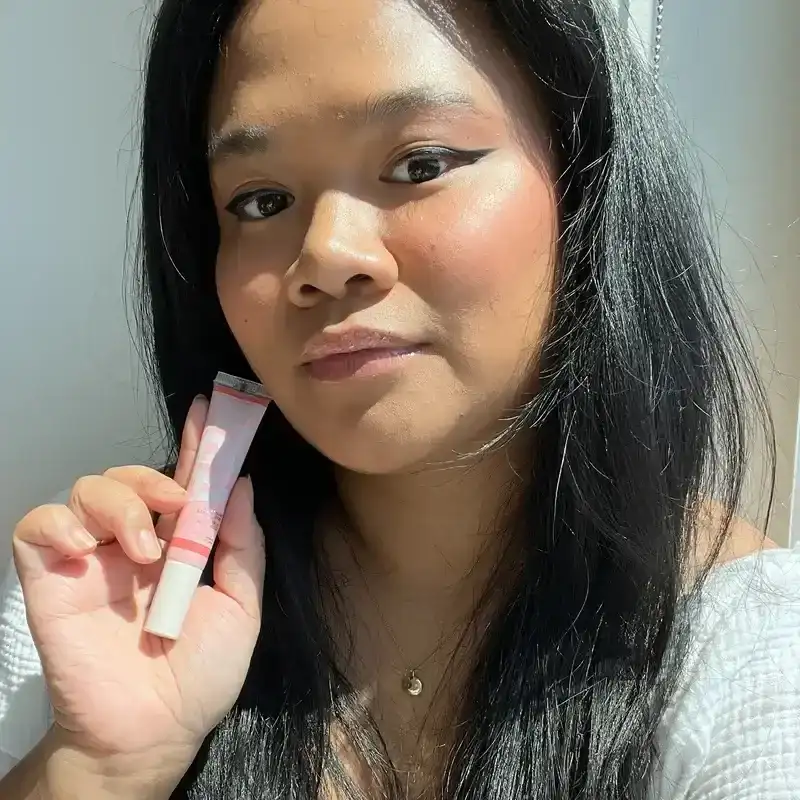 left: senior editor jesa calaor wearing the anastasia beverly hills blurring serum blush on cheeks; right: blurring serum blush in peach 