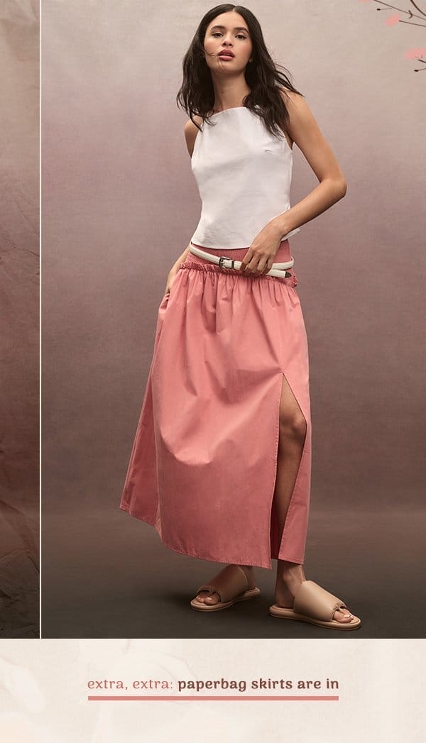 Woman in pink paper bag skirt. Extra, extra: paperbag skirts are in.