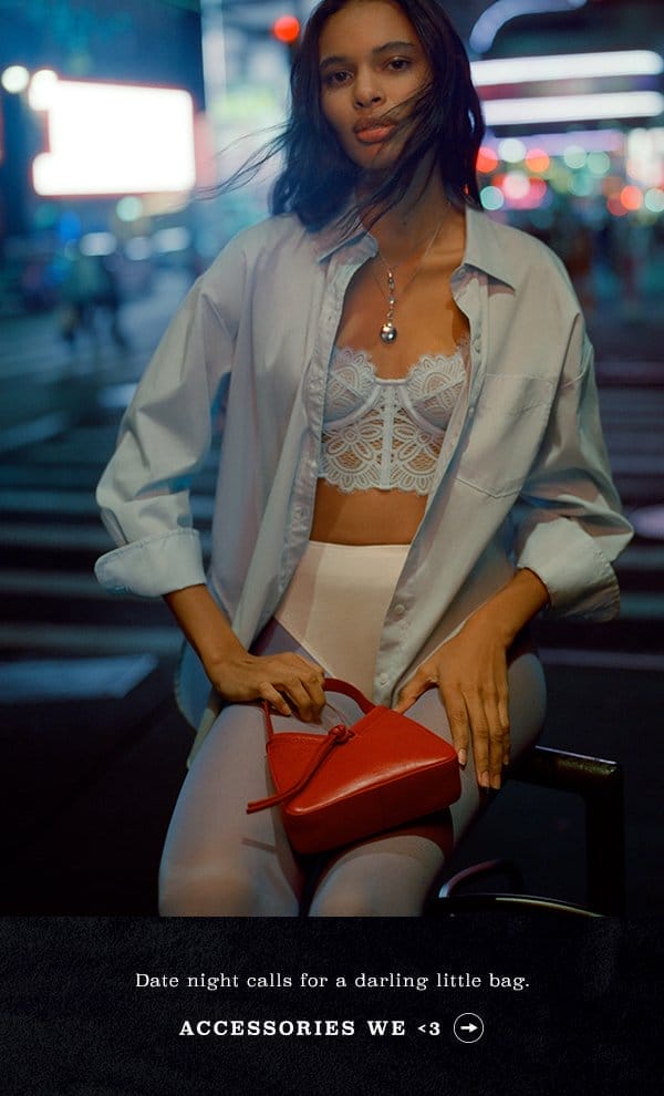 Woman wearing light blue bra and button down. Accessories we love.