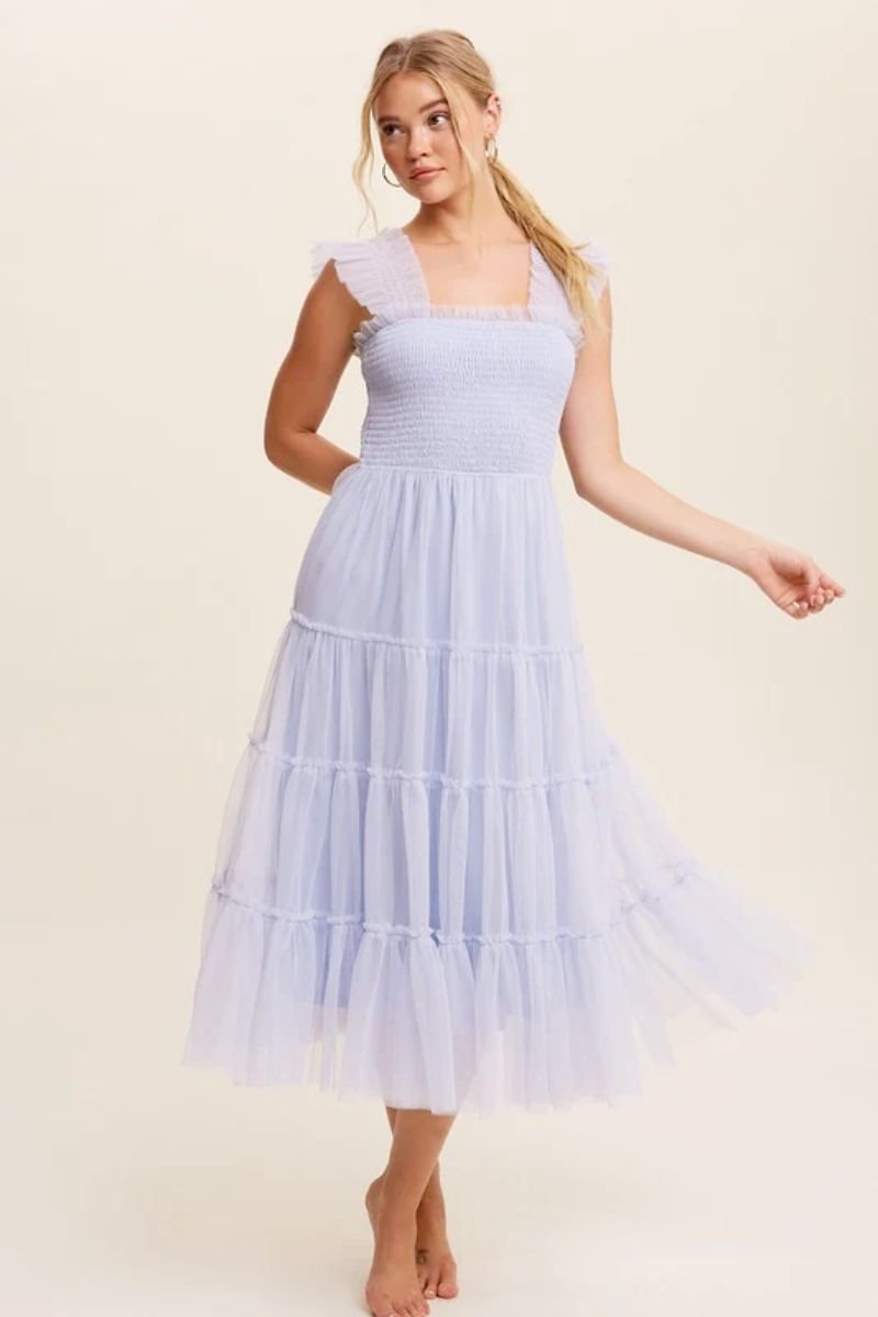 Smocked Ruffle Tiered Mesh Midi Maxi Dress. The model is wearing a light blue mesh dress with multiple tiers and smocked ruffle shoulder straps. The bodice is fitted as well.