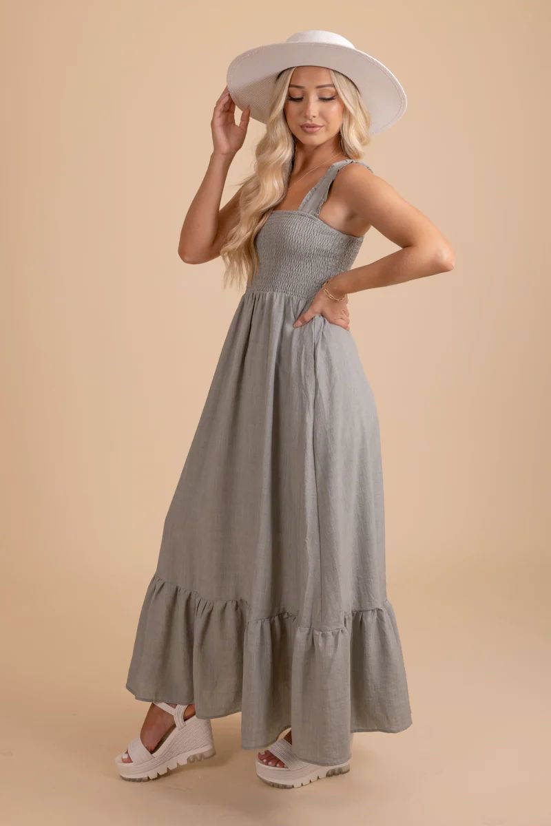 Whimsical Love Tiered Maxi Dress. The model is wearing an light green dress with large straps and a white hat and shoes.