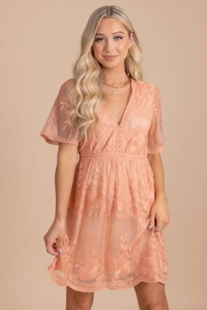 Light My Fire Peach Lace Mini Dress. The model is wearing a lace dress that ends above the knees and she has blonde hair.