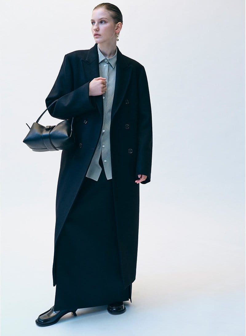 Model wears Toteme - Long Tailored Wool Overcoat