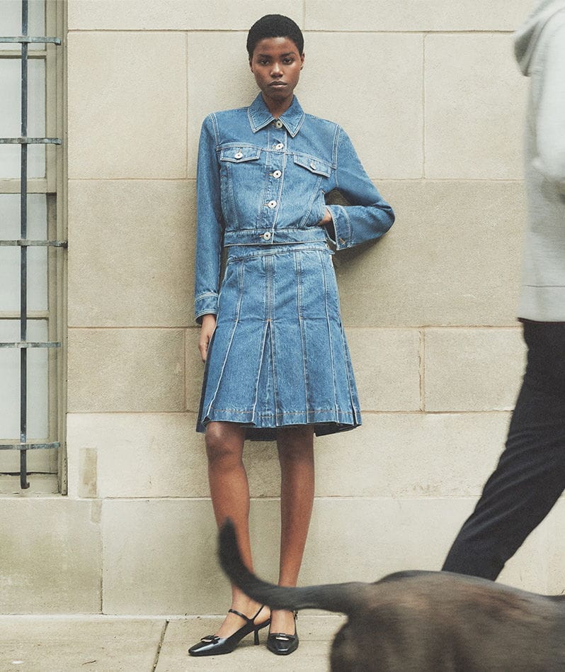 Model Wears Ferragamo - Fitted Denim Jacket and Denim Pleated Mini Skirt