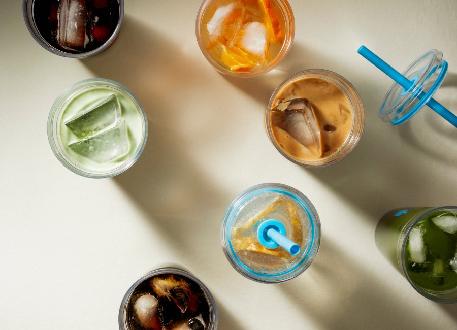 Image of multiple Clear Cold Tumblers filled with colorful prepared iced beverages.