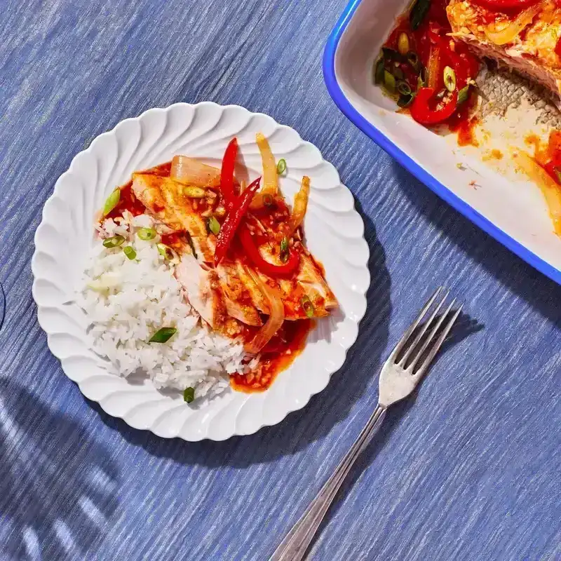 A plate of Saucy Sambal Salmon served with white rice 