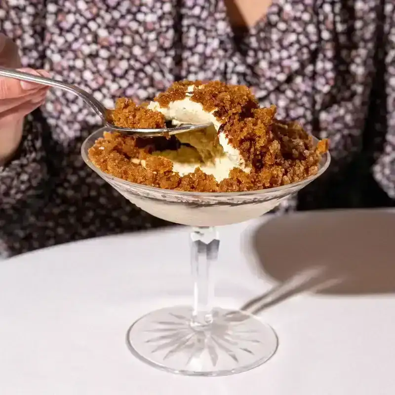 A person scooping out some ice cream from an Affogato