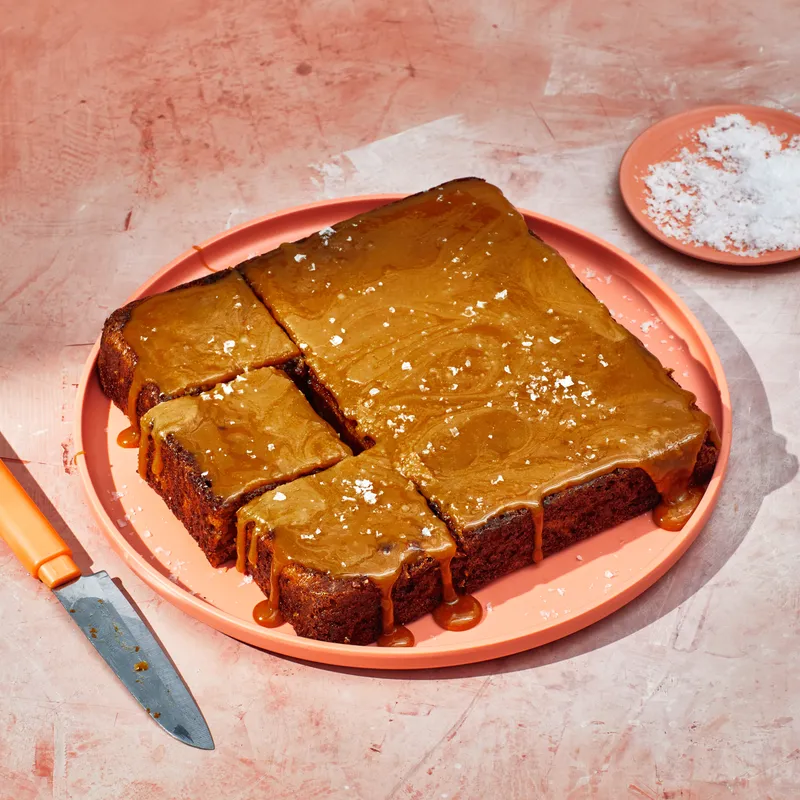 Gooey glazed cake on pink plate.