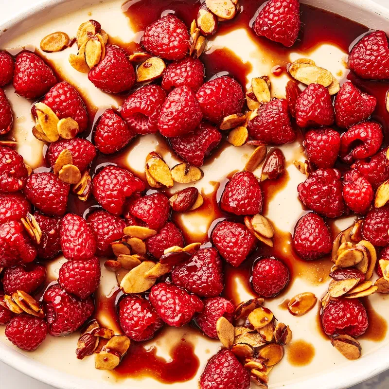 Macro shot of Panna Cotta with raspberries on top