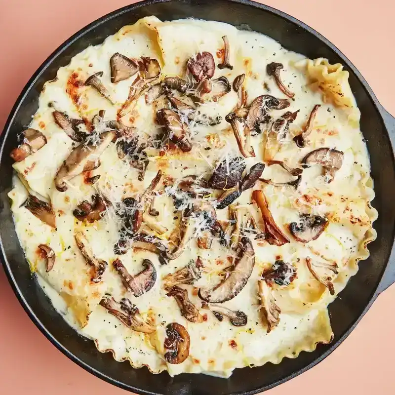 Lasagna with mushrooms in cast iron skillet