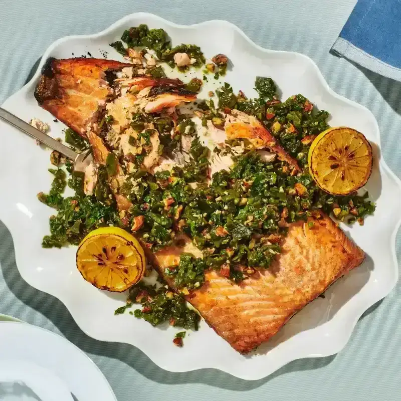 Grilled Salmon With Green Romesco on a white plate