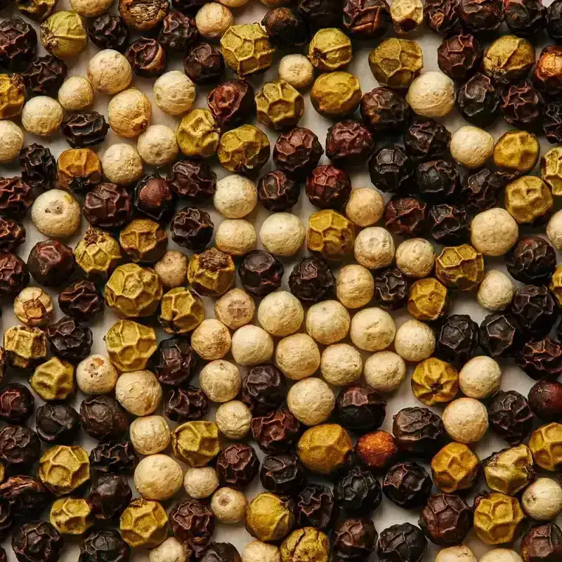 a closeup of various types of peppercorns 