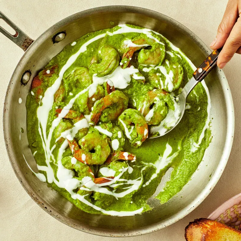 overhead view of Green Shrimp in a pan and Grilled Bread to the side in a bowl