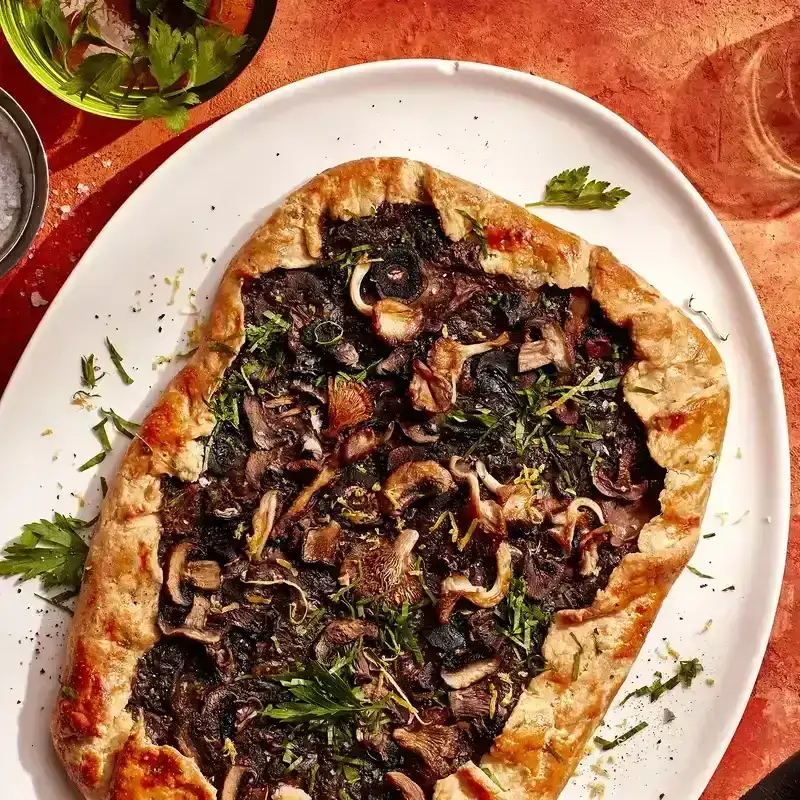 A rectangular Cheesy Mushroom Galette on a white serving platter