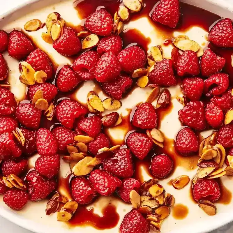 Macro shot of Panna Cotta with raspberries on top