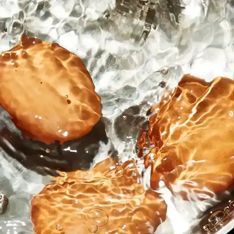 Eggs submerged in boiling water for our best hard-boiled egg recipe.