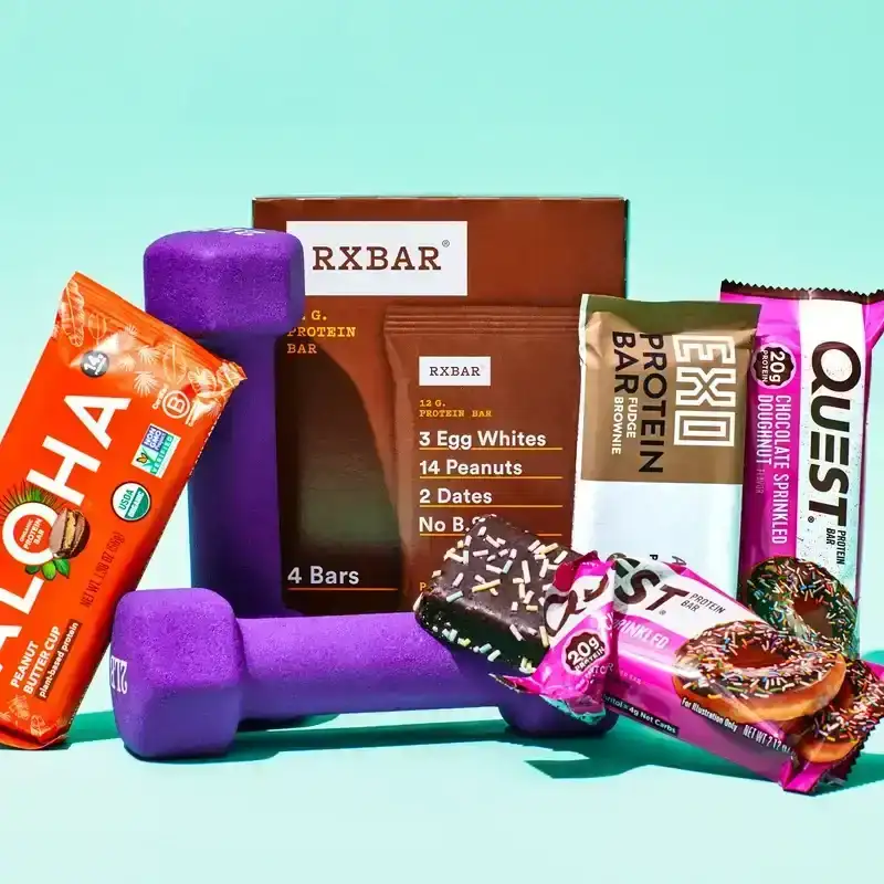 A display of the best protein bars, pictured with purple dumbbells