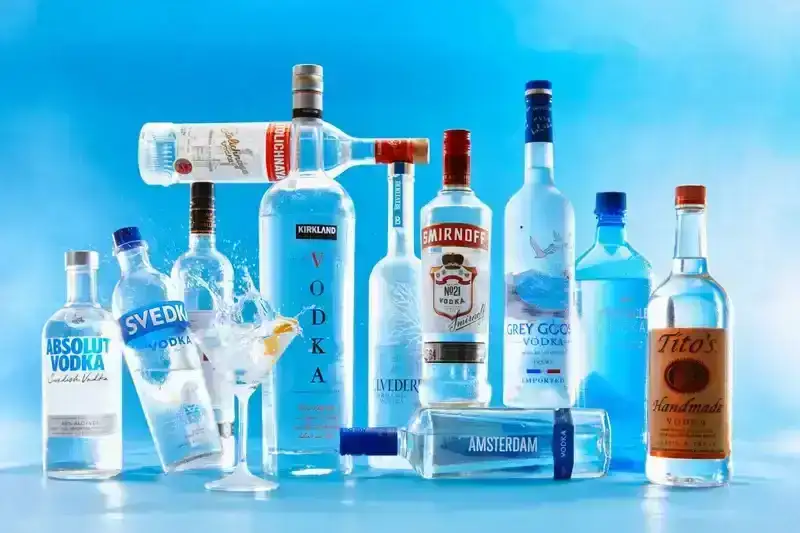Variety of Vodka bottles on an ice blue background