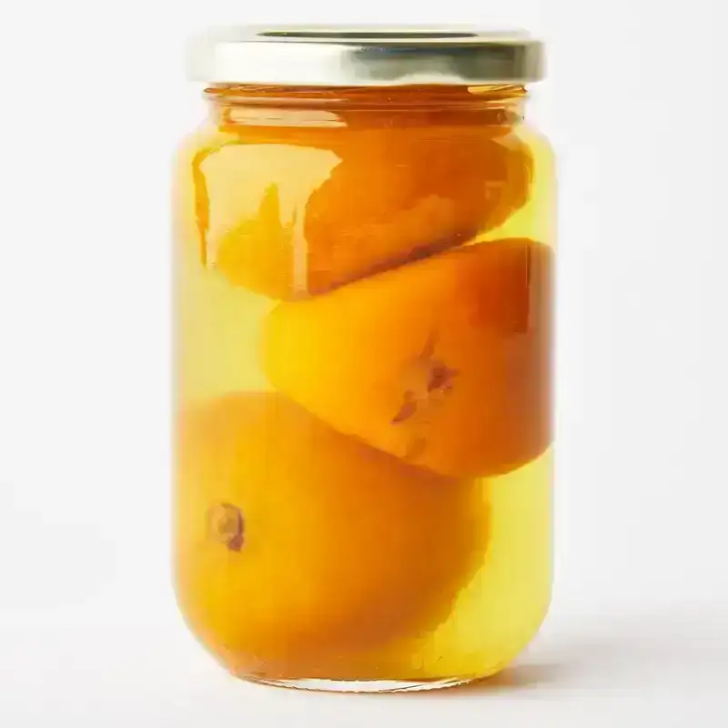 A jar of preserved lemons in brine.