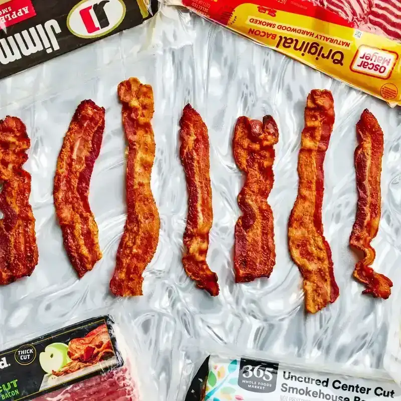 strips of bacon surround by packages of bacon 