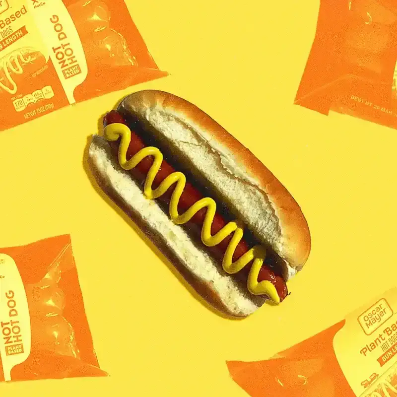 still of a vegan hot dog and hot dog packaging