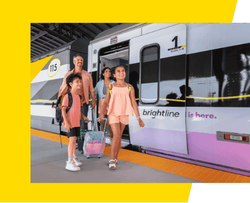 Family walking out Brightline train.