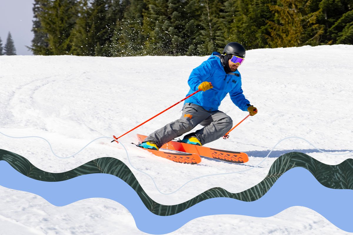 Two people on a ski mountain pointing off in the distance