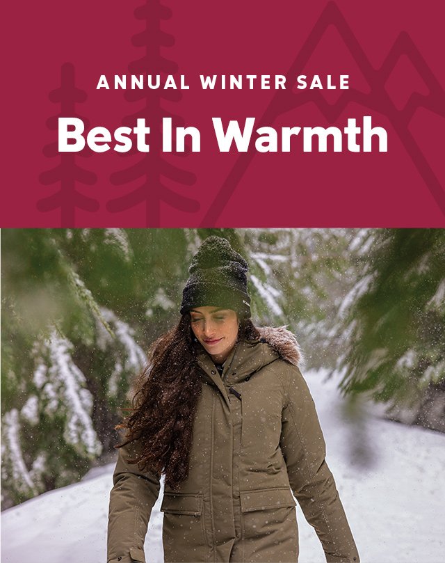 A woman looking cozy in her top-rated winter insulated jacket. Headline: Winter Winners.