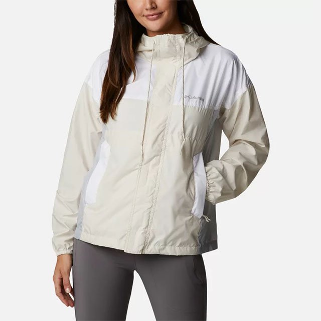 Model in a white and off-white windbreaker.