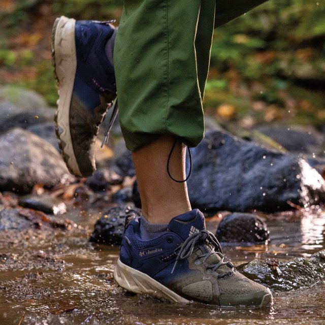 A waterproof sneaker crosses over a muddy stream with ease.