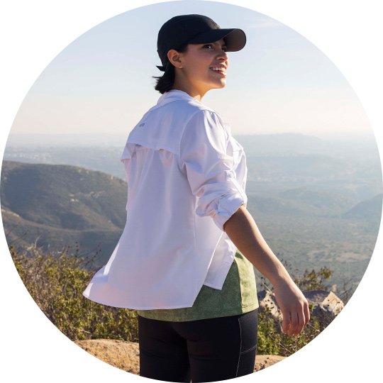 Woman smiling in Titanium hiking gear. 