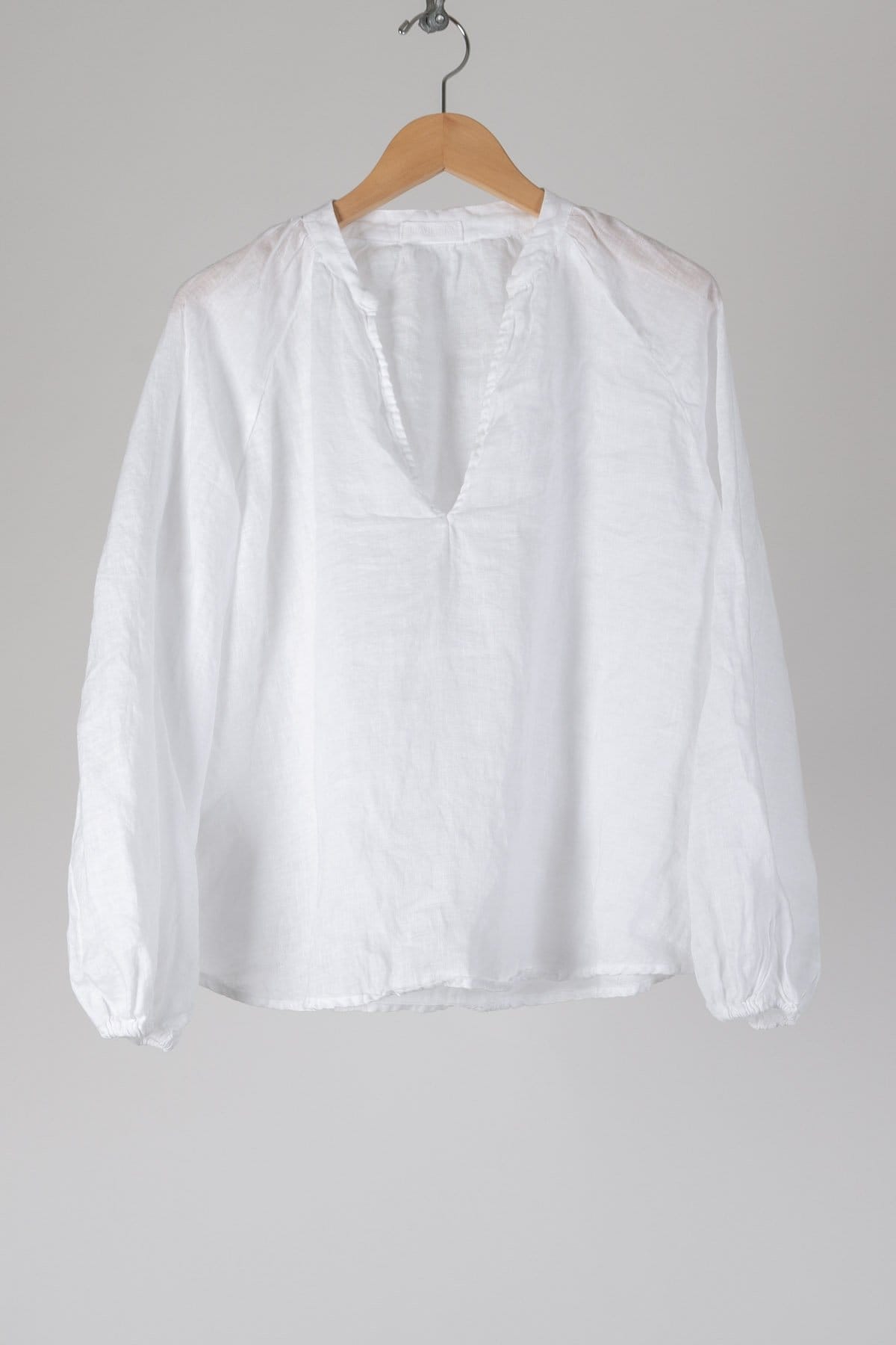 A v-neck blouse with a billowy cut and elastic at the wrists.