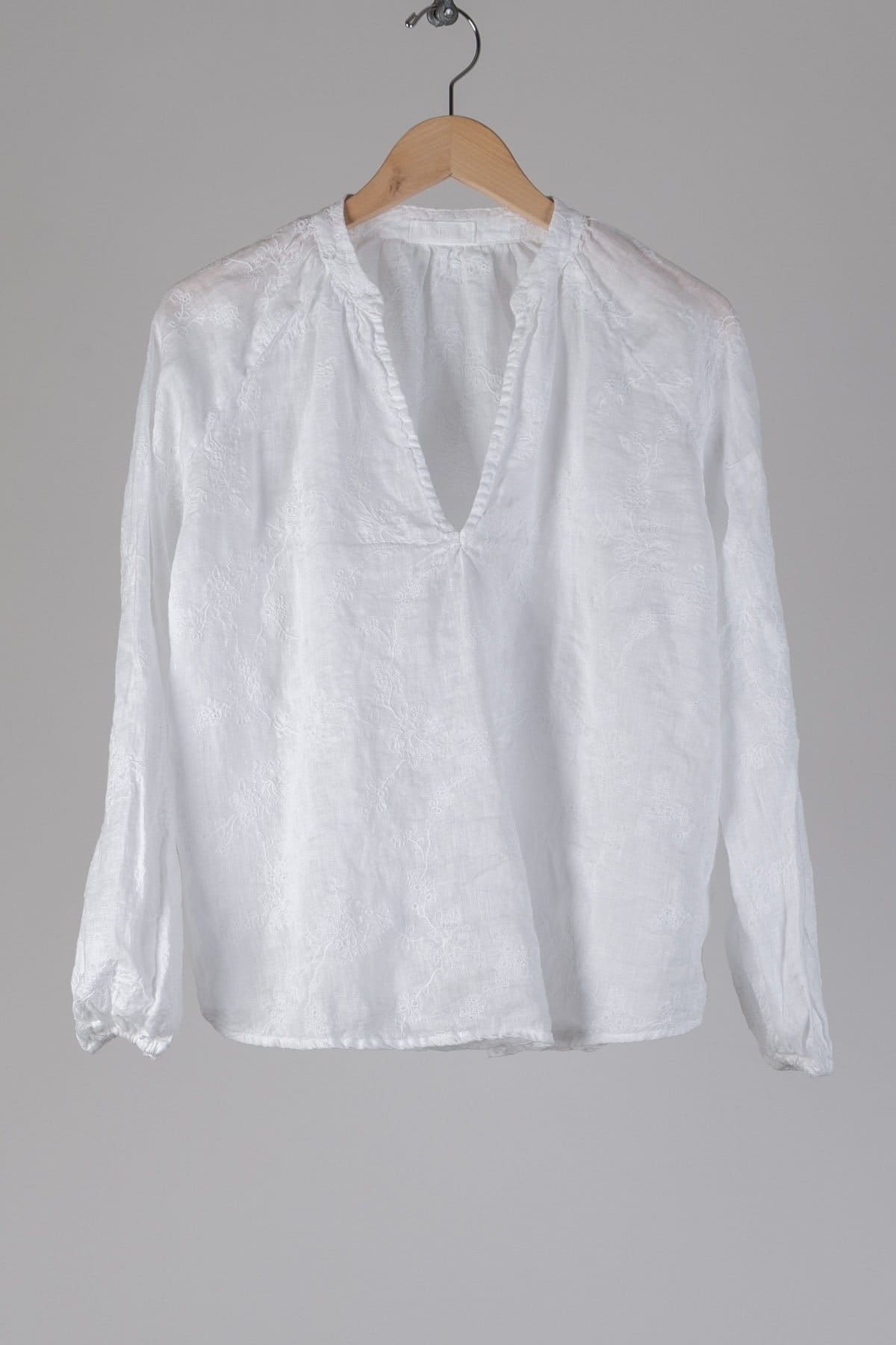 A v-neck blouse with a billowy cut and elastic at the wrists. in Embroidered Linen