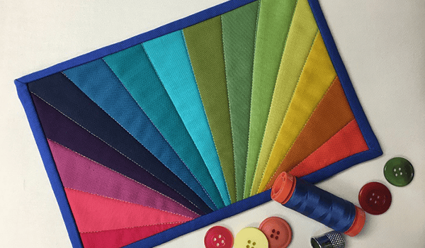 This Paper Pieced Rainbow Mug Rug Is Bursting With Color