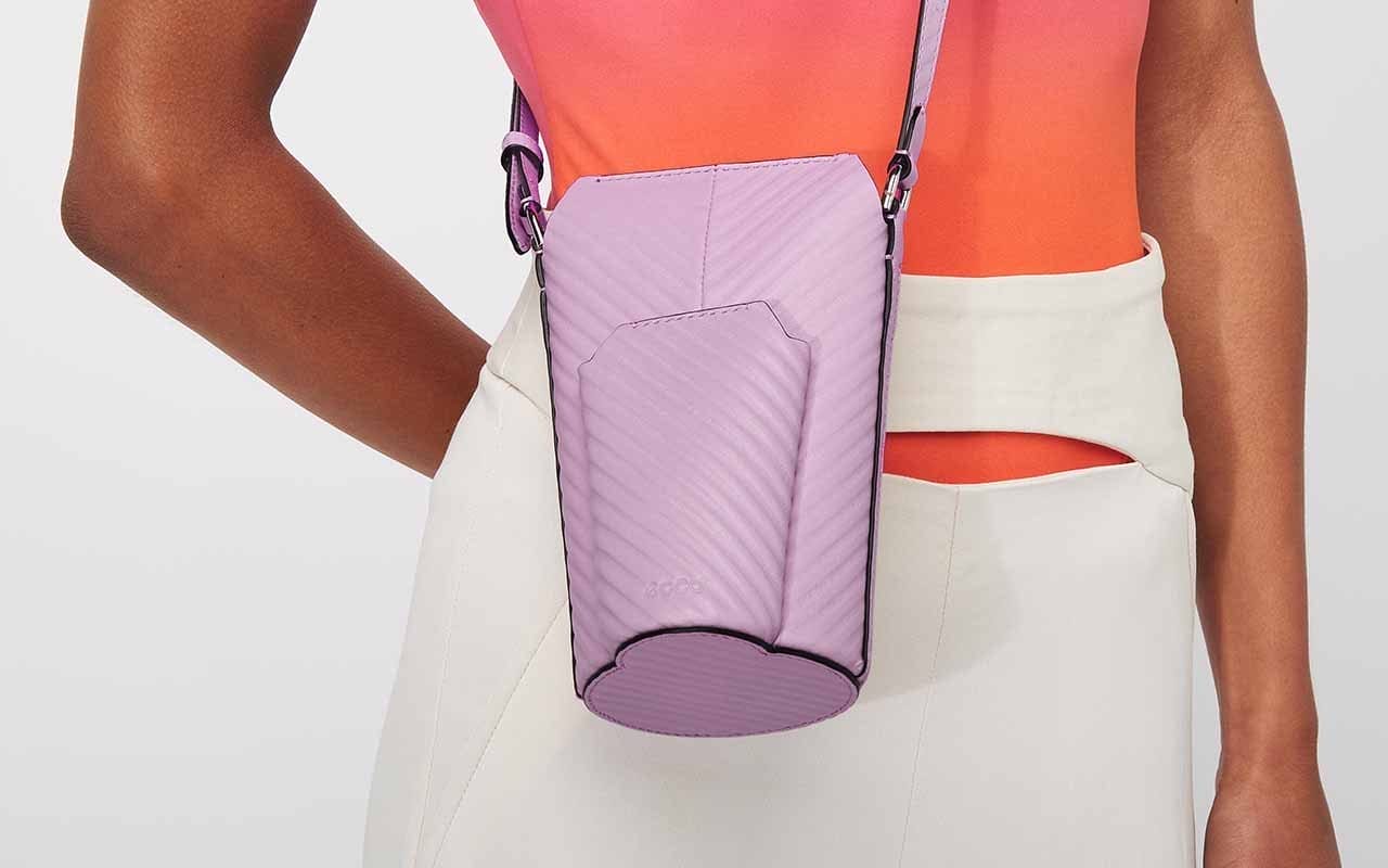 Woman wearing purple crossbody bag