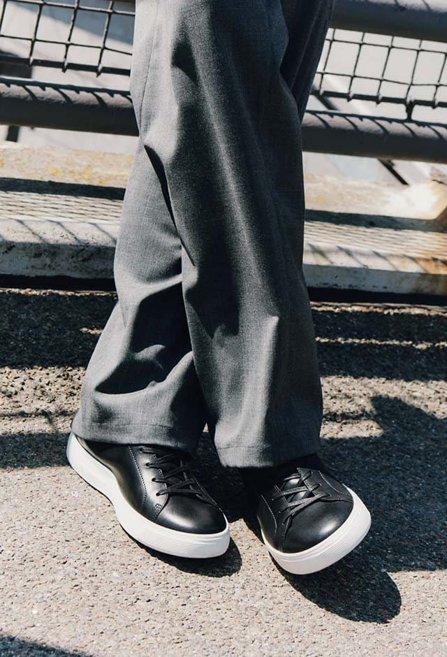 Man wearing black casual sneakers